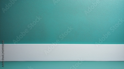 Elegant turquoise wall with white baseboard in a well-lit indoor setting at m...