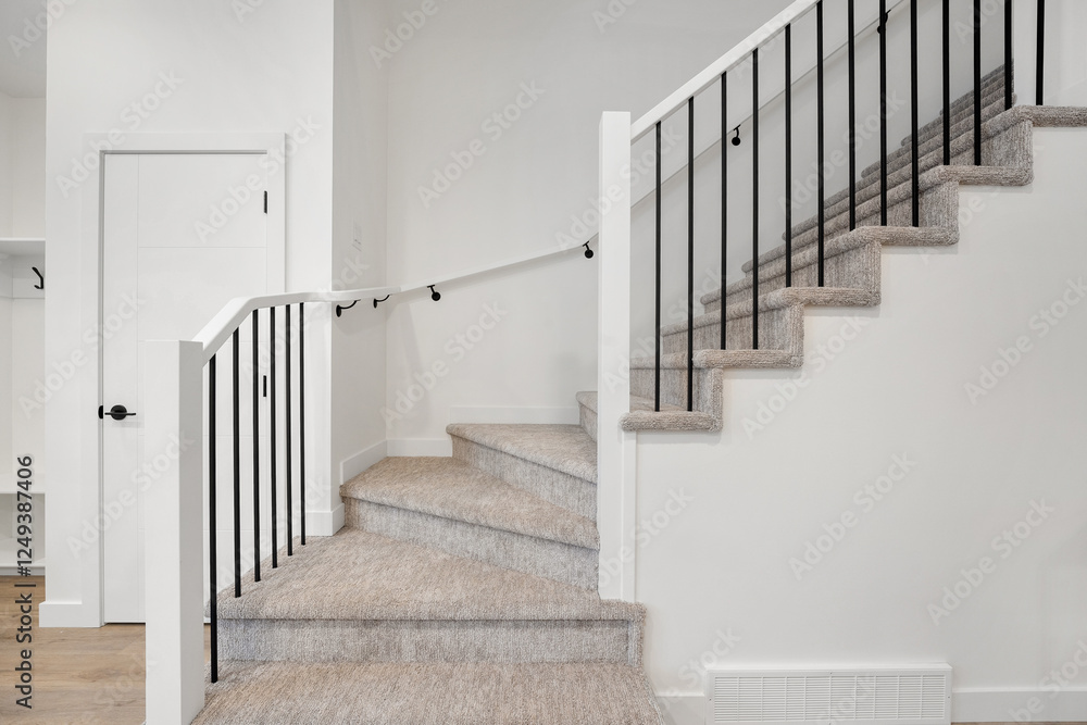A staircase with a railing and a white door in the background A staircase with a railing and a white door in the background