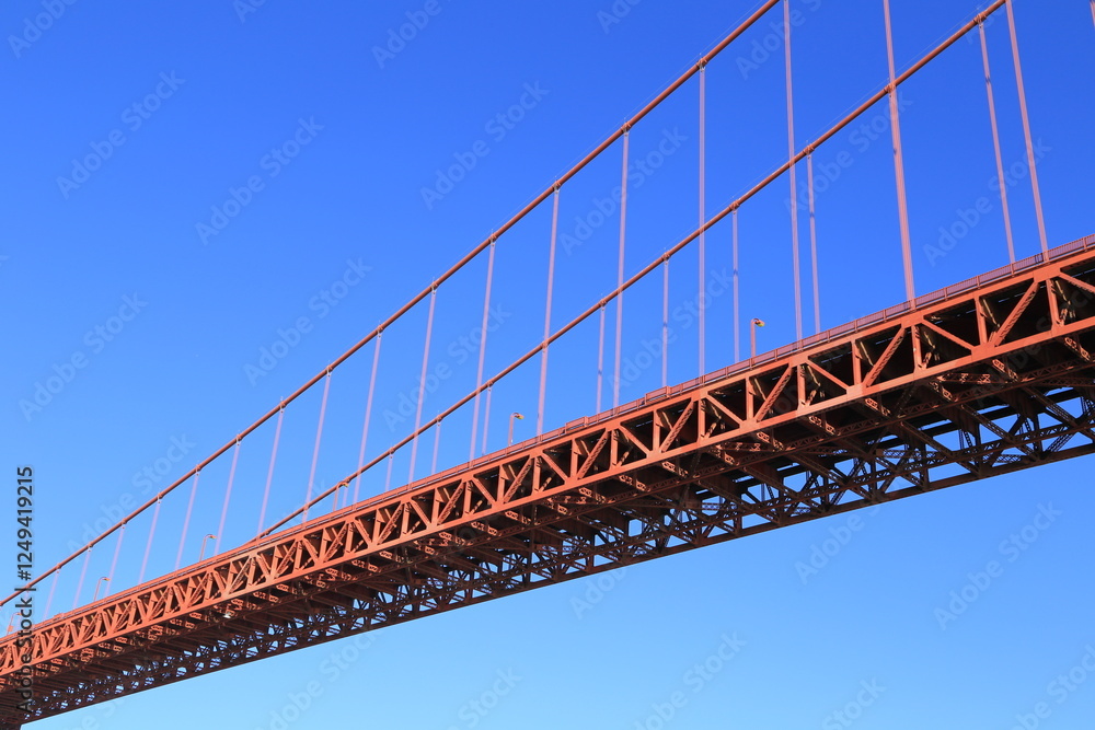 Golden Gate Bridge Close-Up with Steel Framework Against a Clear Blue Sky Golden Gate Bridge Close-Up with Steel Framework Against a Clear Blue Sky