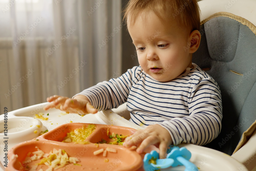 A curious baby sits in a high chair, engaged with a colorful tray of food. The little one plays with the food, showing excitement and concentration in a warm, inviting home environment A curious baby sits in a high chair, engaged with a colorful tray of food. The little one plays with the food, showing excitement and concentration in a warm, inviting home environment