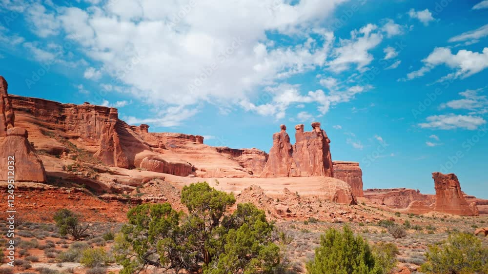 Road trip PoV along the Three Gossips in Arches National Park, Utah. Like many of the rock formations in the park, Three Gossips is composed of Entrada Sandstone. Road trip PoV along the Three Gossips in Arches National Park, Utah. Like many of the rock formations in the park, Three Gossips is composed of Entrada Sandstone.