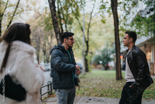 Bilde på lerret A group of friends engages in a casual conversation while enjoying an outdoor stroll in a picturesque park environment