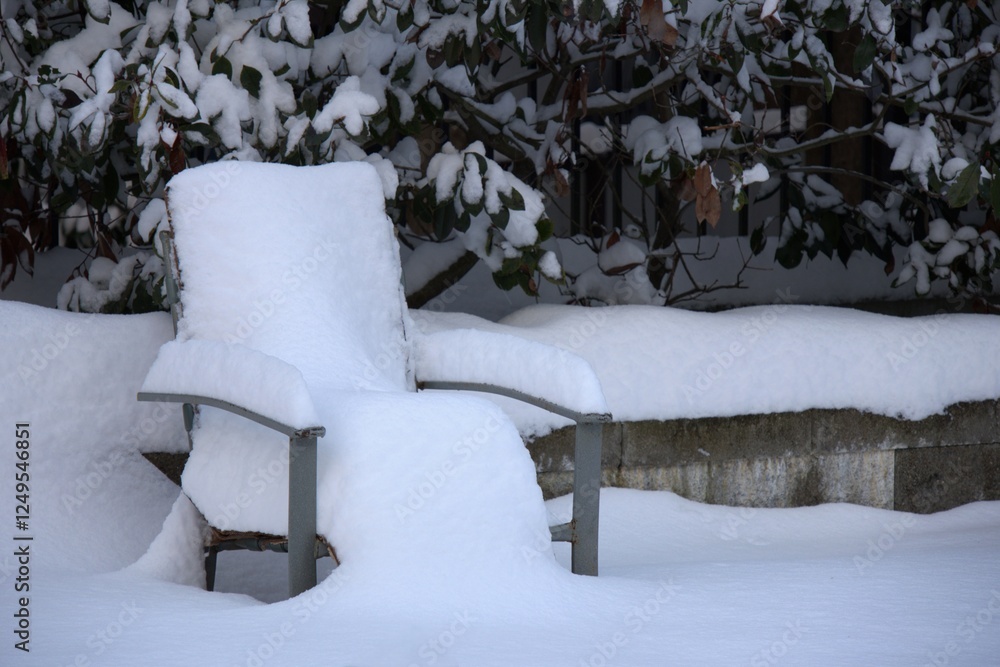 Snow covered a chair outdoors. Time after snowfall. Snow covered a chair outdoors. Time after snowfall.