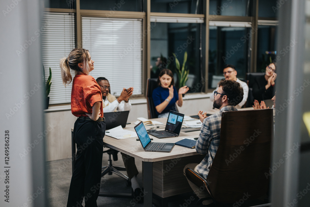 Multicultural group of business people engaged in a late-night brainstorming session in a modern office, discussing strategies and solutions for growth.