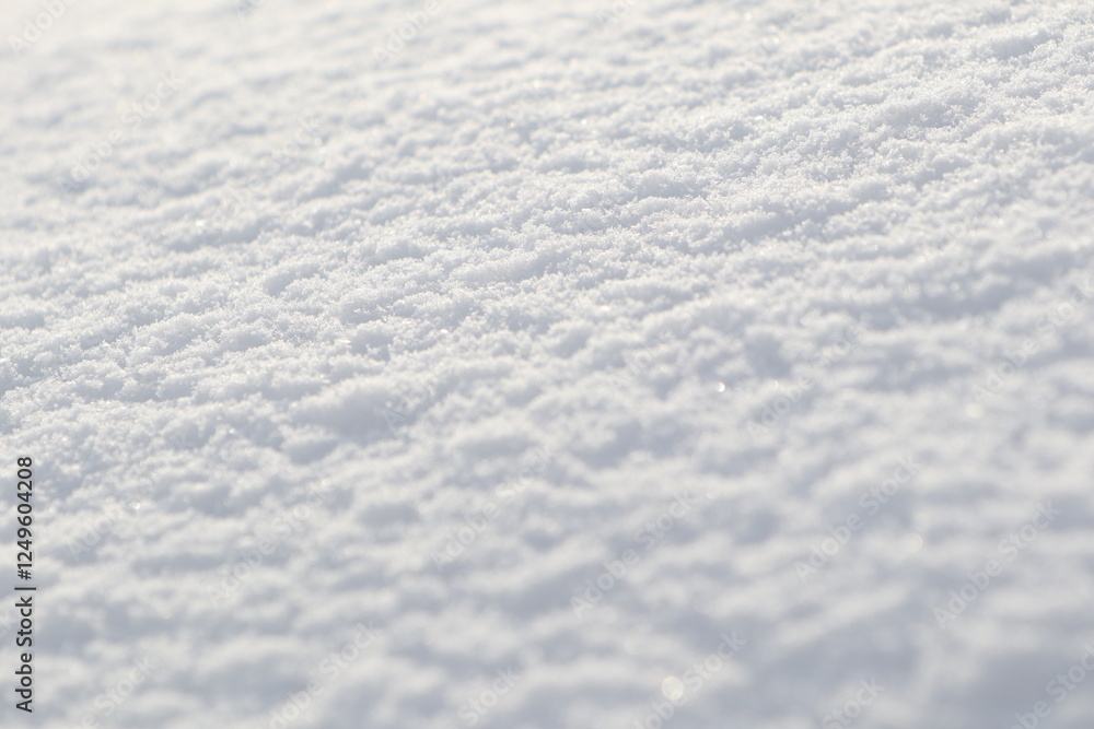A closeup view of the soft and fresh snow surface that glistens in the beautiful winter light A closeup view of the soft and fresh snow surface that glistens in the beautiful winter light