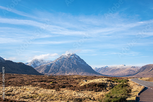 Landscape photography of mountain Buachaille Etive Mor, Glencoe, Scotland, UK, winter, snow on the mountain peak, hiking, valley, viewpoint, scenic, rocky hill, blue sky with clouds, travel