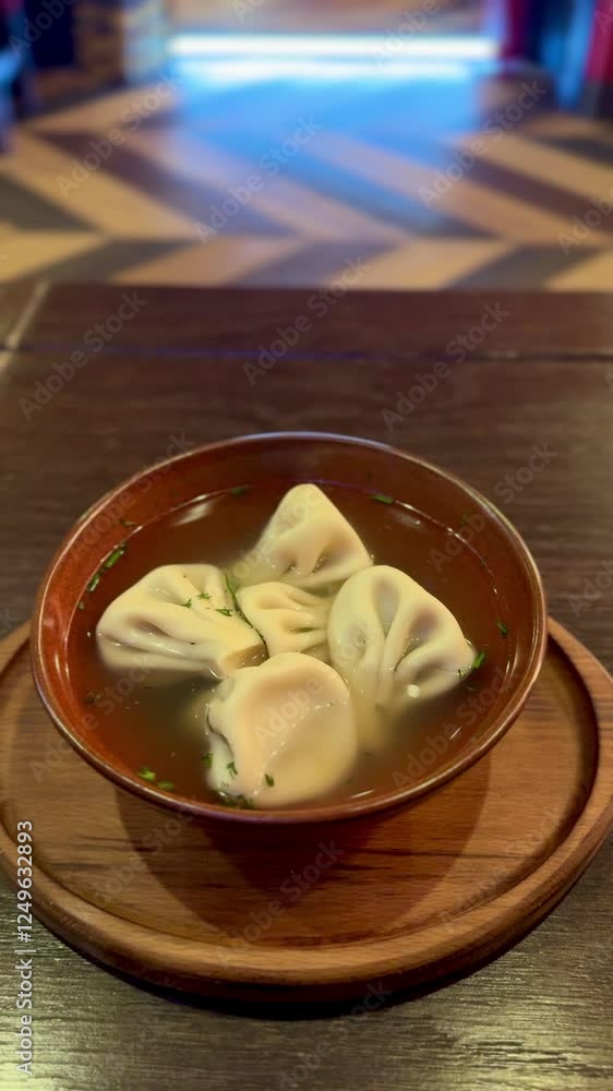 Close-up of view at Homemade Khinkalis in brown dish, Georgian traditional boiled dumpling, serve on ceramic plate. Health food Close-up of view at Homemade Khinkalis in brown dish, Georgian traditional boiled dumpling, serve on ceramic plate. Health food