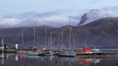 Corpach lighthouse and marina on the shores of Loch Eli with snow capped Ben Nevis and Fort William, Highland region, Scotland, United Kingdom  photo