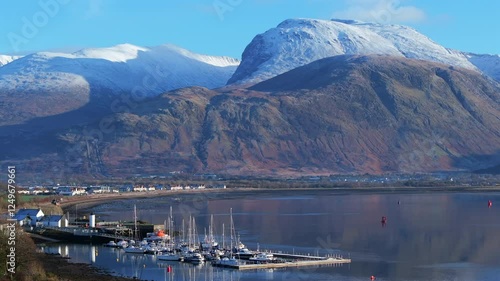 Corpach lighthouse and marina on the shores of Loch Eli with snow capped Ben Nevis and Fort William, Highland region, Scotland, United Kingdom 