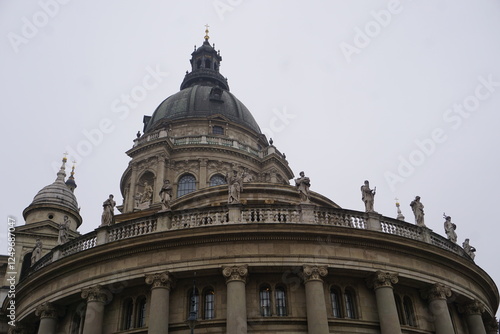 Close up of the church roof of St. Stephen's Basilica, Budapest, Hungary, with its landmark dome, ornate columns, and historic statues photo