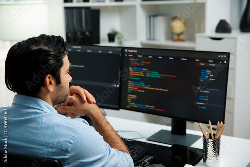 Concentrating in smart IT developer working software development coding on two pc screen, creating virus firmware application program for latest update version on website at modern office. Surmise. photo