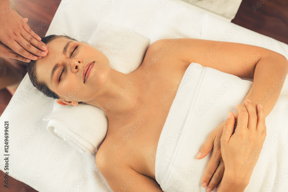 Panorama top view of woman enjoying relaxing anti-stress head massage and pampering facial beauty skin recreation leisure in dayspa modern light ambient at luxury resort or hotel spa salon. Quiescent Panorama top view of woman enjoying relaxing anti-stress head massage and pampering facial beauty skin recreation leisure in dayspa modern light ambient at luxury resort or hotel spa salon. Quiescent