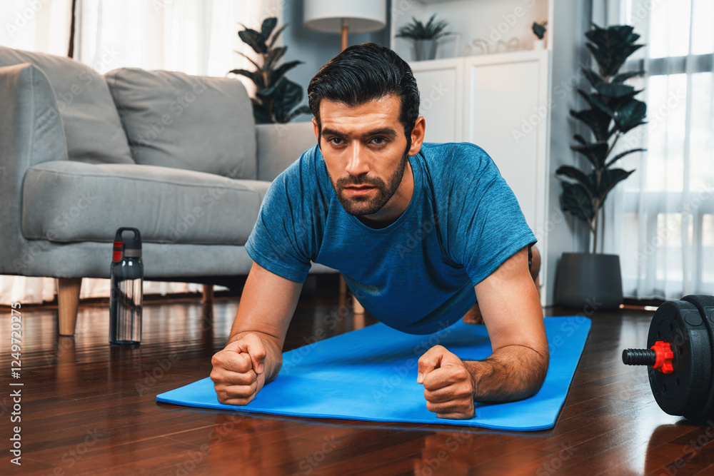 Fototapeta premium Athletic and sporty man doing plank on fitness mat during home body workout exercise session for fit physique and healthy sport lifestyle at home. Gaiety home exercise workout training.