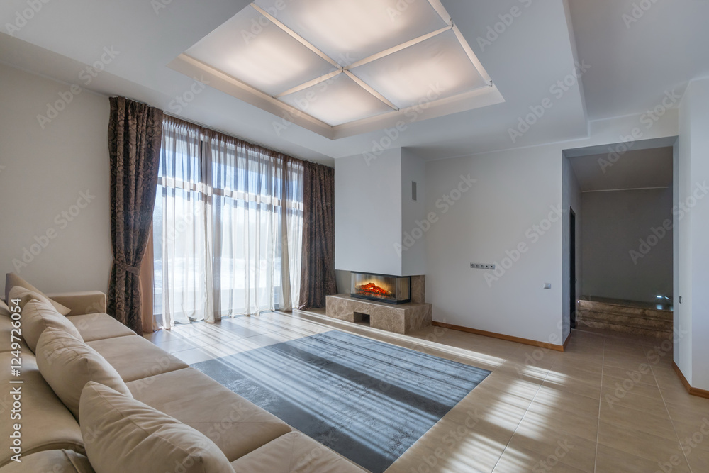 The sun rays on the floor of the living room with a modern interior. Soft ceiling lighting. The sun rays on the floor of the living room with a modern interior. Soft ceiling lighting.
