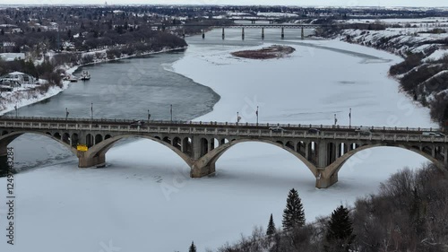 Bridge over a river with snow on the ground. The bridge is covered in ice and snow