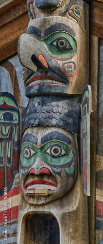 Traditional colorful first nations totem pole standing tall photo