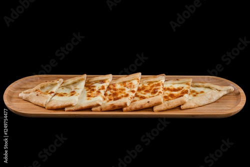 Turkish pitta with kashar cheese. Turkish pide with cheese. Pita is traditional Turkish pizza. Turkish name; Peynirli Pide. Isolated on black background. photo