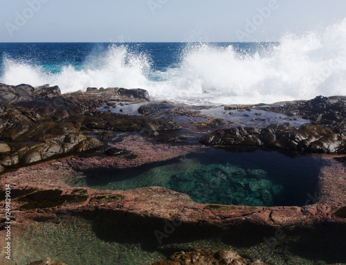 Gran Canaria, north coast, rockpools around Puertillo de Banaderos area protected from the 
ocean waves by volcanic rock barrier photo