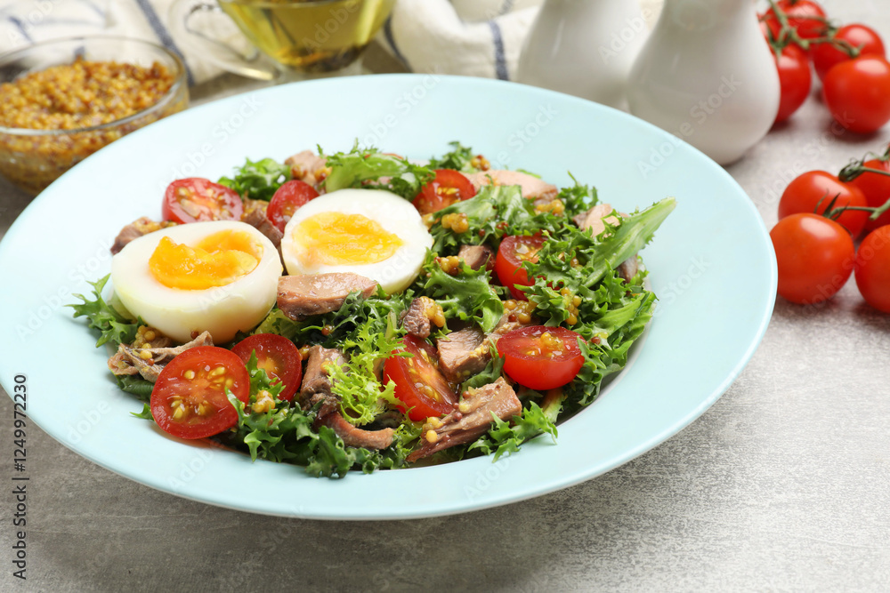 Delicious fresh tuna salad on grey textured table, closeup Delicious fresh tuna salad on grey textured table, closeup