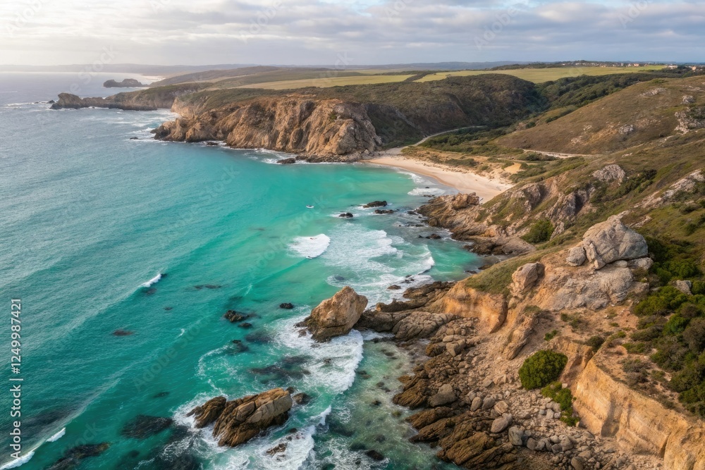 Aerial view of a coastline with rocky cliffs and turquoise waves crashing against the shore at low tide, wave, blue, landscape