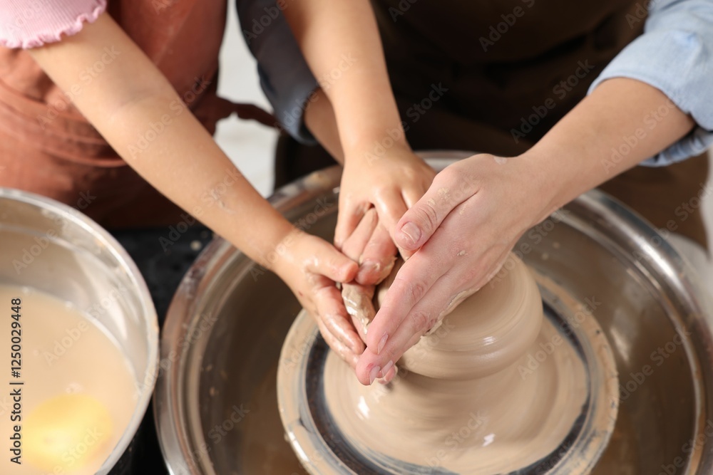 Hobby and craft. Mother with her daughter making pottery indoors, closeup Hobby and craft. Mother with her daughter making pottery indoors, closeup