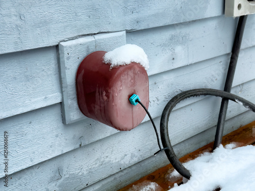 Outdoor home spigot or faucet cover for cold weather during winter season to prevent frost