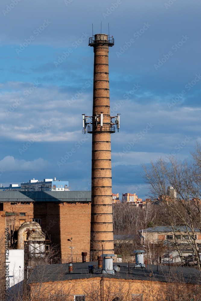 Technical staircase with railing around a brick chimney.