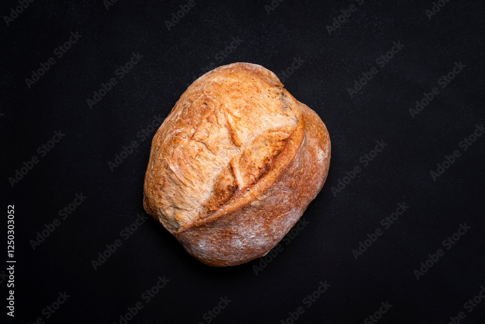 Homemade whole grain freshly baked bread. Black background, top view Homemade whole grain freshly baked bread. Black background, top view