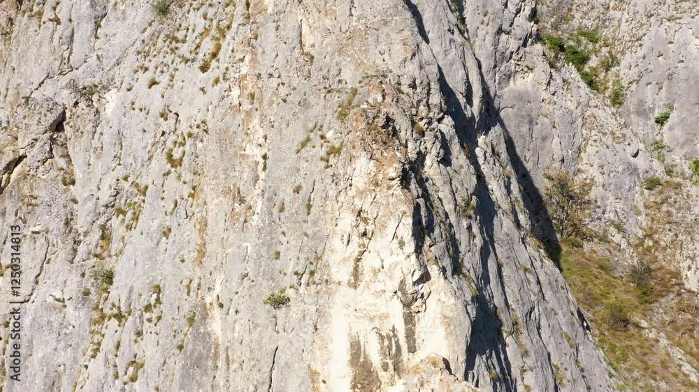 Flying through vertical limestone walls in a deep gorge, canyon, rock climbing aerial Flying through vertical limestone walls in a deep gorge, canyon, rock climbing aerial