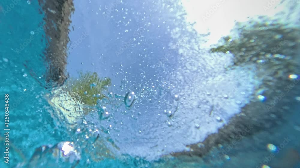 Underwater view of air bubbles rising in swimming pool Underwater view of air bubbles rising in swimming pool