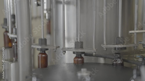 Syrup Bottles getting filled with liquid medicine in automatic machine slog footage. photo