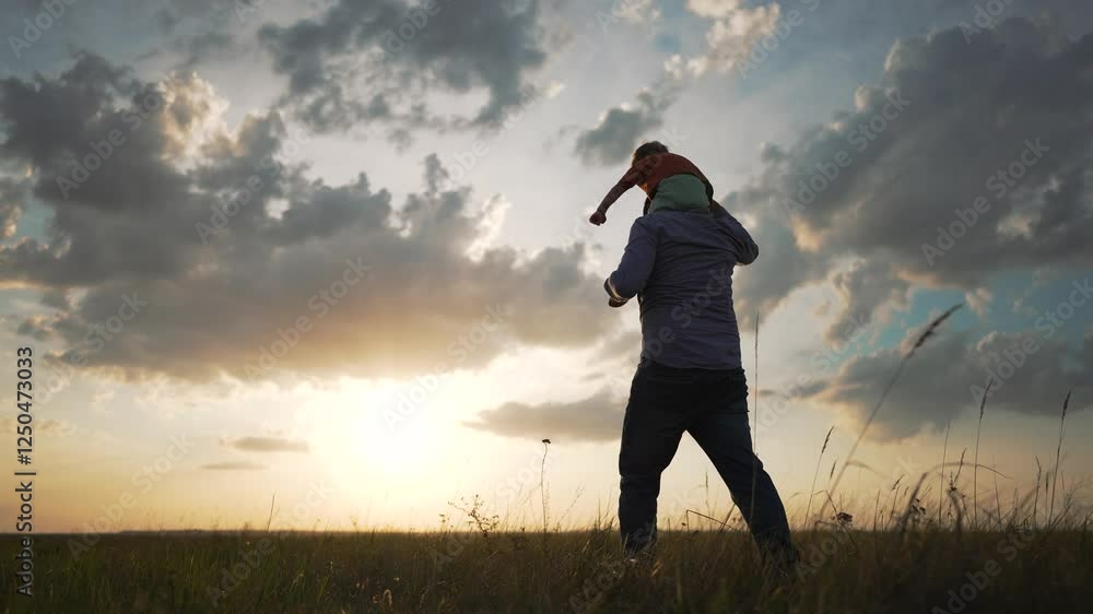 Father with child shoulders. family time together. Silhouette man carrying child scenic field. Emotional bond between family members. Concept family and togetherness. Family bonding outdoors together. Father with child shoulders. family time together. Silhouette man carrying child scenic field. Emotional bond between family members. Concept family and togetherness. Family bonding outdoors together.