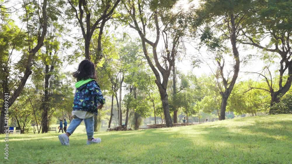 Little kindergarten girl run on green meadow grass public park sunset light outdoor relax slow motion Little kindergarten girl run on green meadow grass public park sunset light outdoor relax slow motion