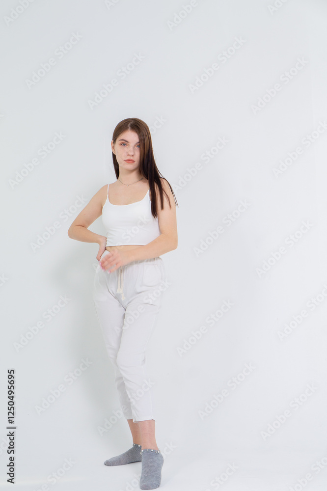 Cute young brunette standing on a white background. Copyspace Cute young brunette standing on a white background. Copyspace
