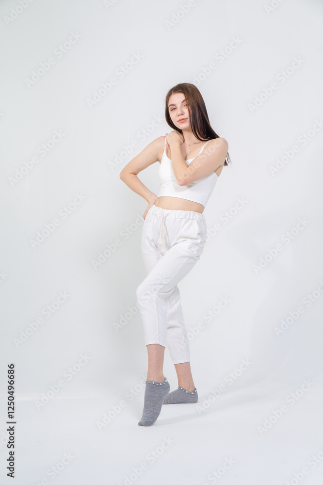 Cute young brunette standing on a white background. Copyspace Cute young brunette standing on a white background. Copyspace