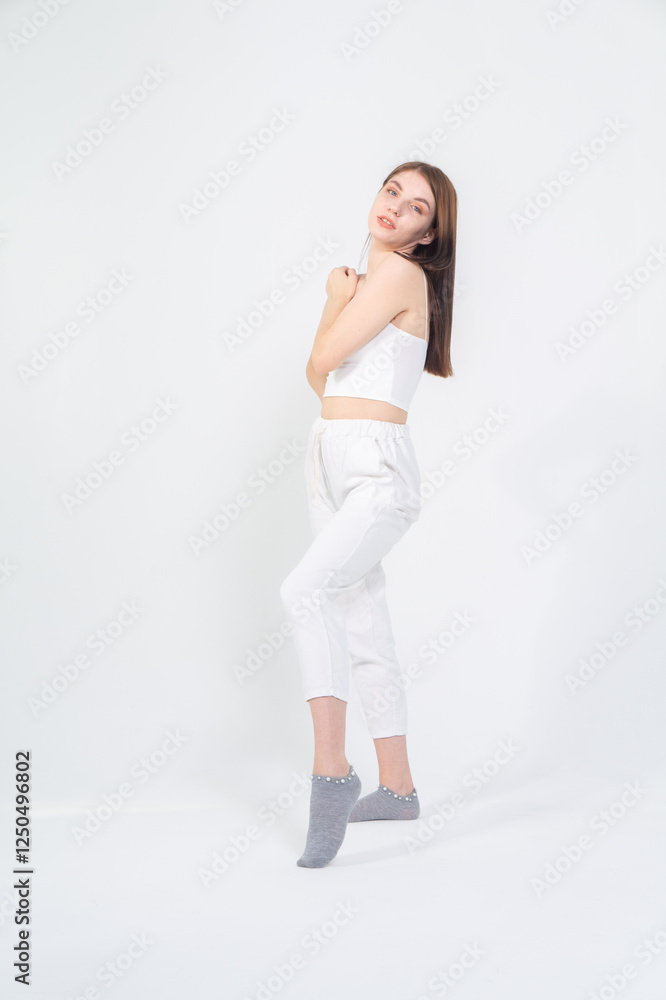 Cute young brunette standing on a white background. Copyspace Cute young brunette standing on a white background. Copyspace