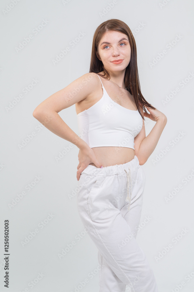 Young cute brunette girl standing on a white background. Copyspace Young cute brunette girl standing on a white background. Copyspace