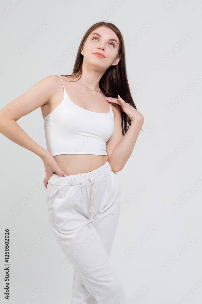 Young cute brunette girl standing on a white background. Copyspace Young cute brunette girl standing on a white background. Copyspace