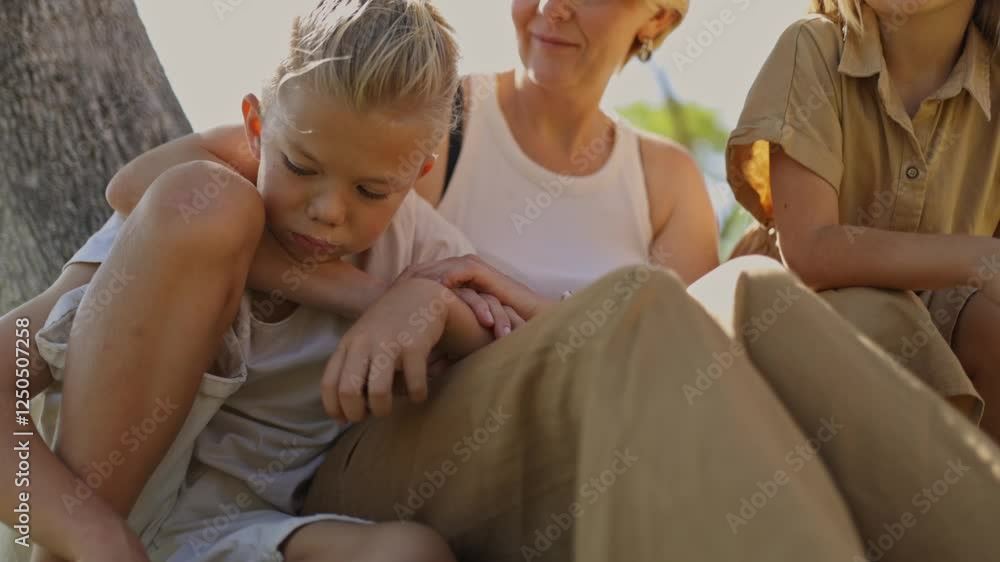 Family enjoying quality time together under a tree Family enjoying quality time together under a tree
