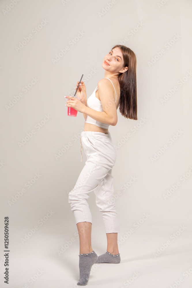 Young pretty girl with a cocktail on a white background Young pretty girl with a cocktail on a white background