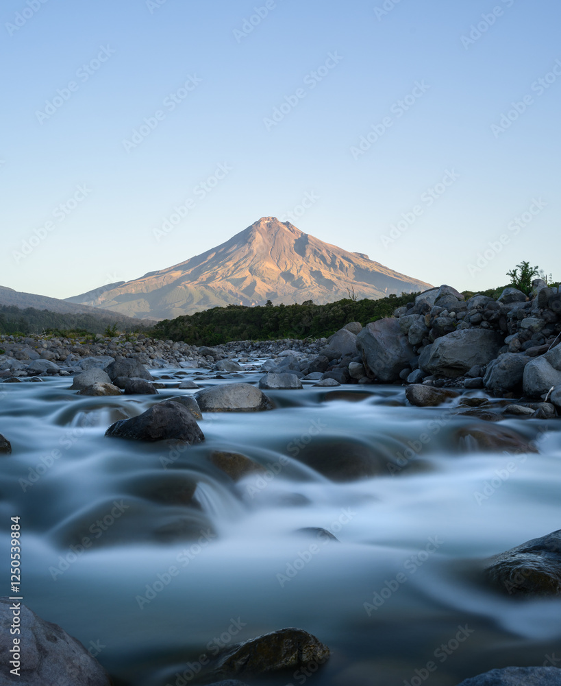 Mt Taranaki with Stonely River in the foreground at sunset. New Zealand.