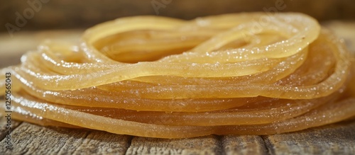 Macro shot of tangled strands of gluten free spaghetti pasta on a rustic wooden surface photo