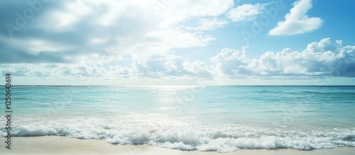 Serene ocean view with gentle waves under a cloudy sky and sunlight illuminating the water for a tranquil coastal atmosphere. photo