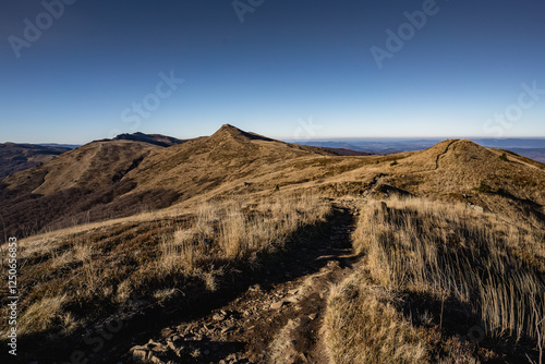 Scenic autumn landscapes from a trekking loop in Bieszczady, featuring views from Tarnica, Halicz, Rozsypaniec, Bukowe Berdo, Połonina Wetlińska, and the Ukrainian Bieszczady under a clear blue sky photo