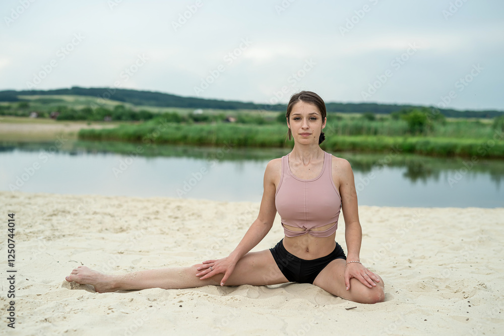 young fitness woman doing streching exercise on lake beach in summer young fitness woman doing streching exercise on lake beach in summer