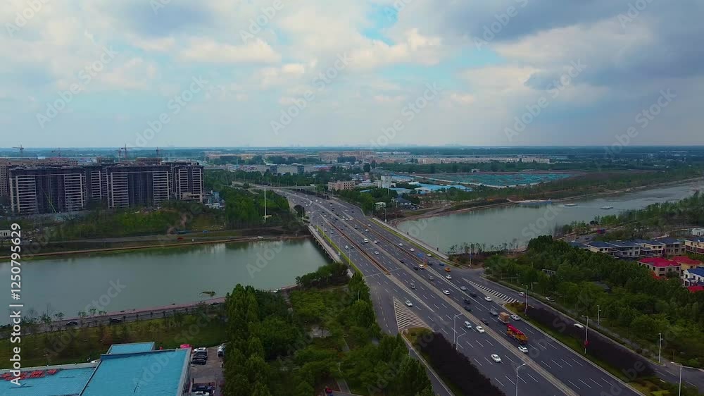 Stunning aerial view of Jalu River along North Huayuan Road in Zhengzhou showcasing urban landscape Stunning aerial view of Jalu River along North Huayuan Road in Zhengzhou showcasing urban landscape
