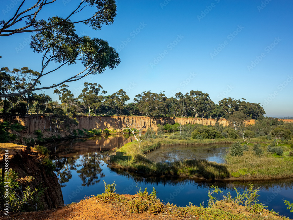 Fototapeta premium Beautiful scenery at Red Cliffs Lookout, overlooking the Werribee River wetlands on the floodplains. A natural landmark and geographical formation in Wyndham, Melbourne, Australia.