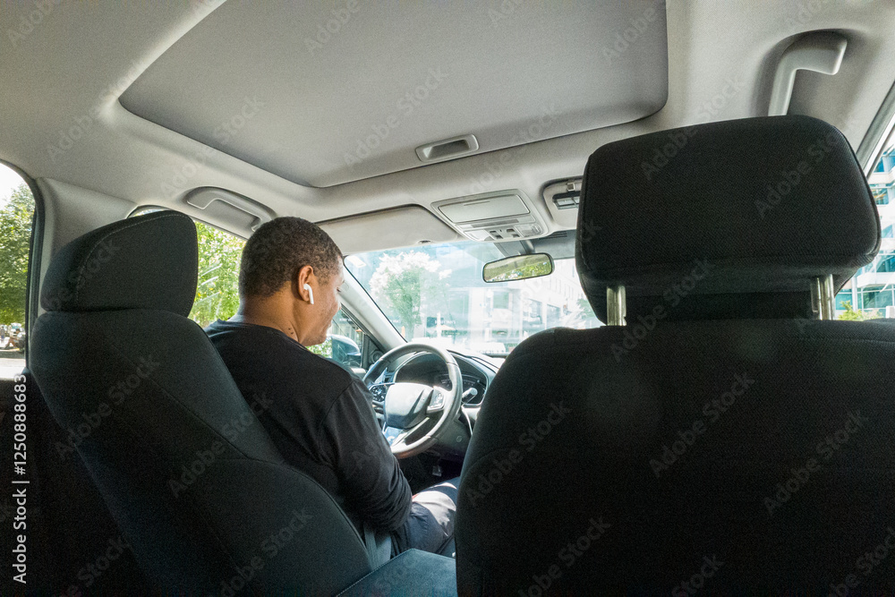 A man is driving a car with a man sitting in the passenger seat A man is driving a car with a man sitting in the passenger seat