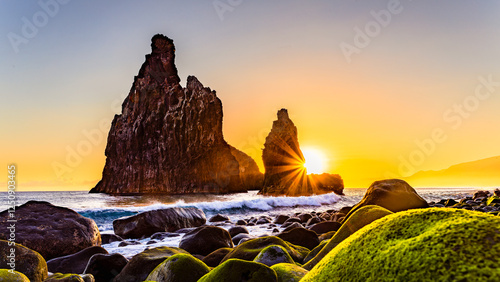 lava rocks in the Atlantic Ocean, island towers in Ribeira da Janela, Madeira Island, Portugal. The rock formations are of volcanic origin in the Atlantic Ocean at sunrise photo