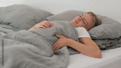 Young Woman with Back Pain while Sleeping in Bed